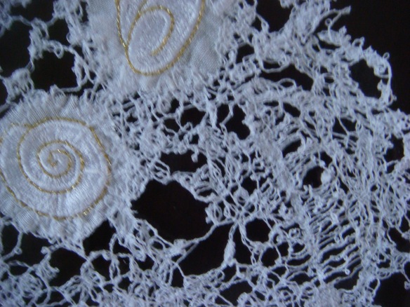 Machined lace . . .  with a feather